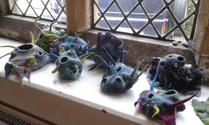 Eight of the finished vessels displayed on a window ledge. looking particularly alien-like