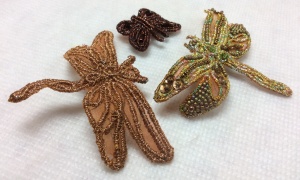 Dragonfly brooches made from organza and wrapped wire.