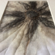 Wet felted Norwegian wool, hand and machine sewn onto a white muslin fabric.