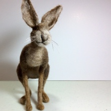 Needle felted brown hare looking towards the viewer